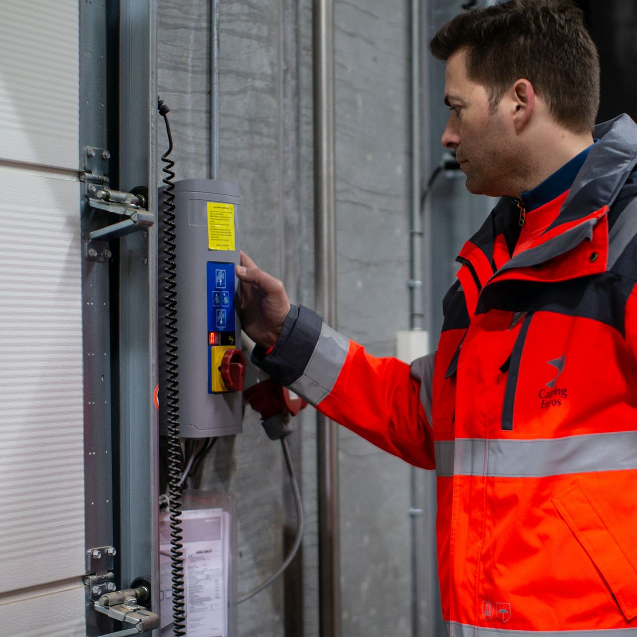 Employee operates dock door of a loading system