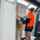 Person painting an undercoat on a door