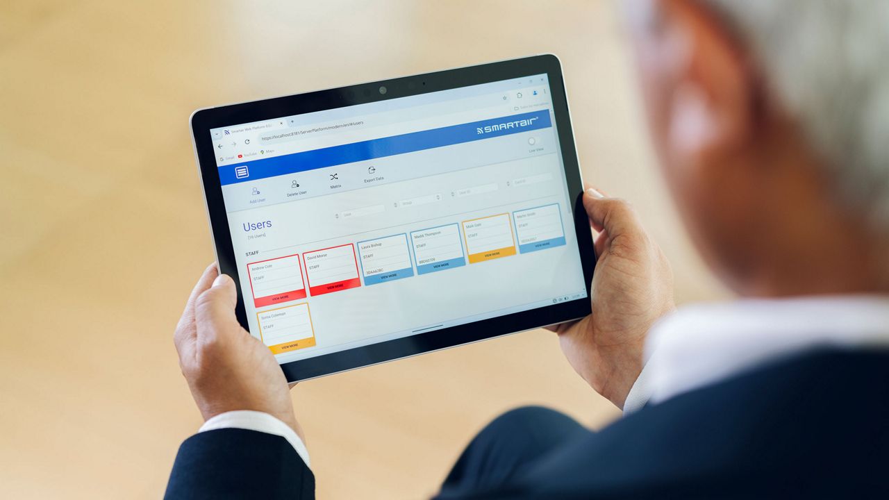 Man viewing SMARTair TS1000 management software on a tablet