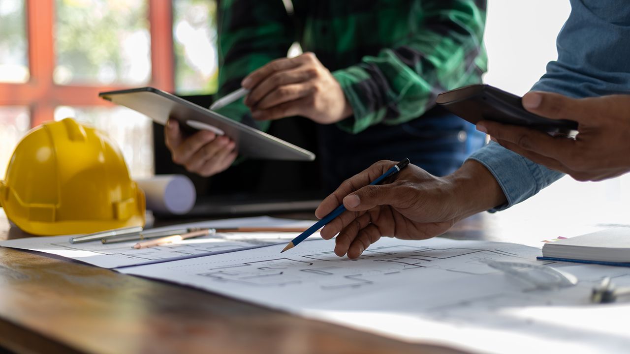 Consultants at a blueprint