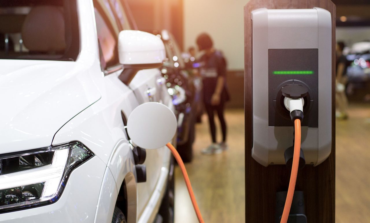 EV being charged in dealership showroom