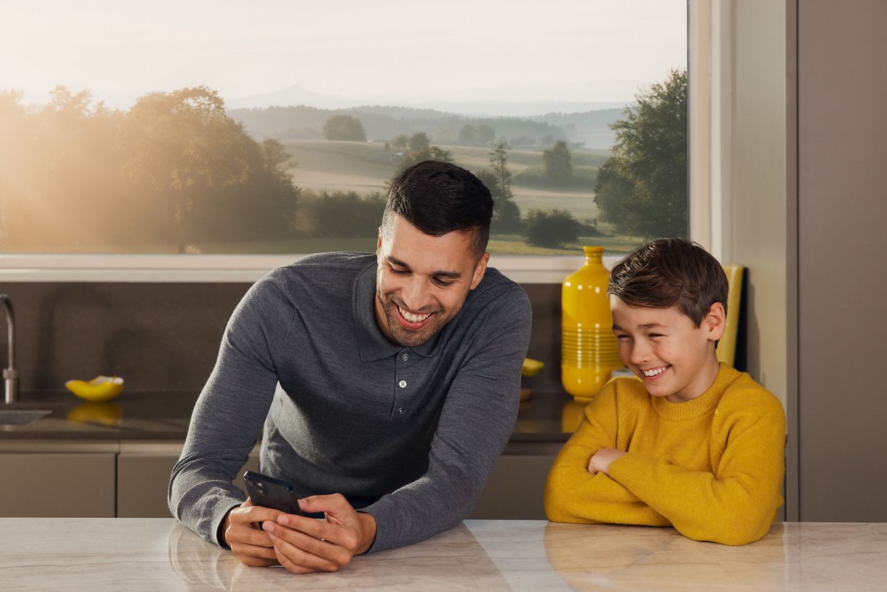 Father and son laughing in the kitchen