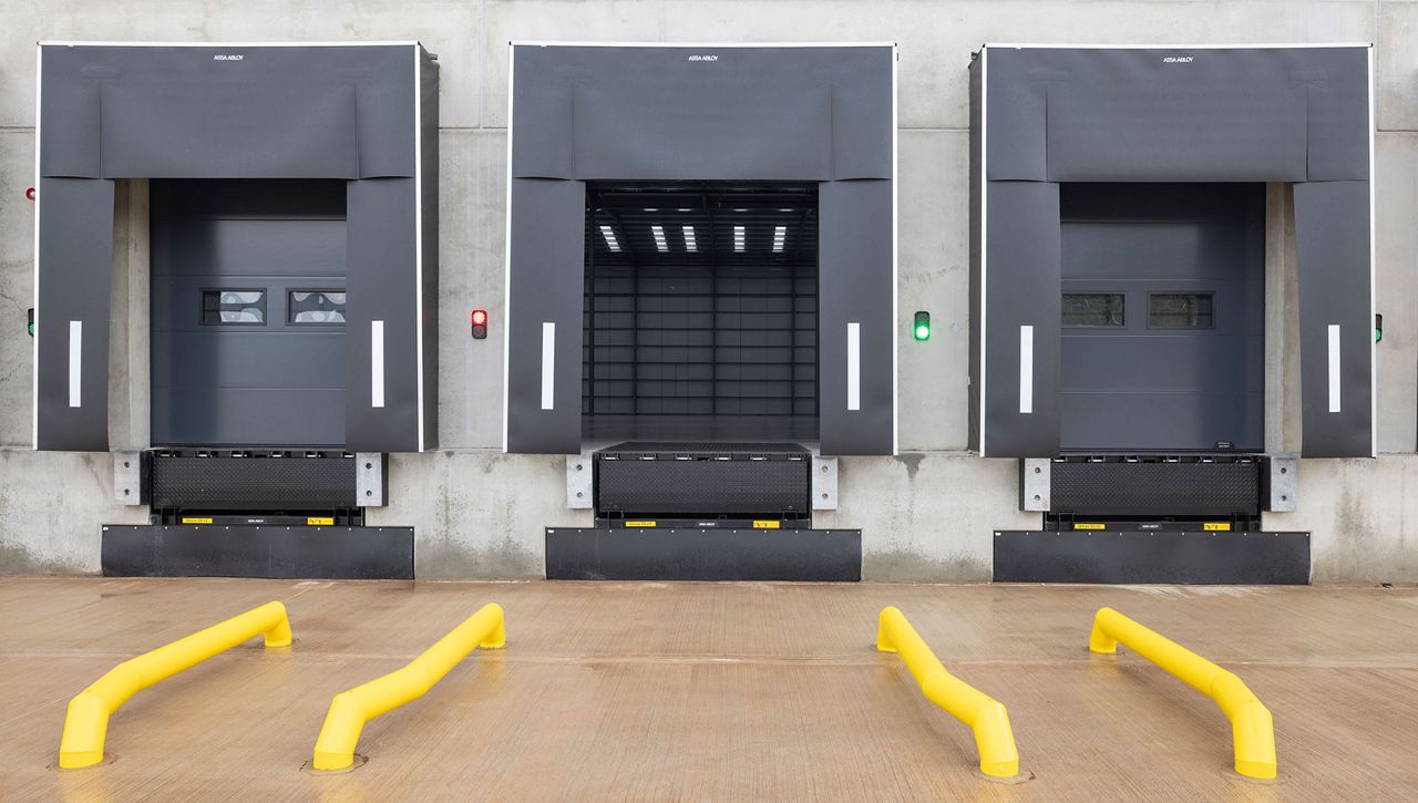 Image: External view of the Crawford OH1142P dual drive sectional door as part of a loading bay at Fradley Park