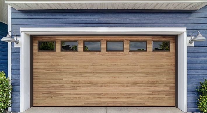 Northwoods plank garage door in Dune with Short Panel windows