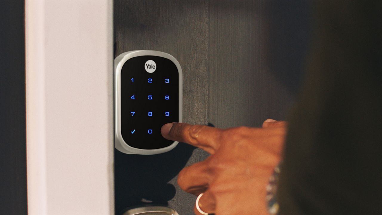 Fingers pressing on keypad