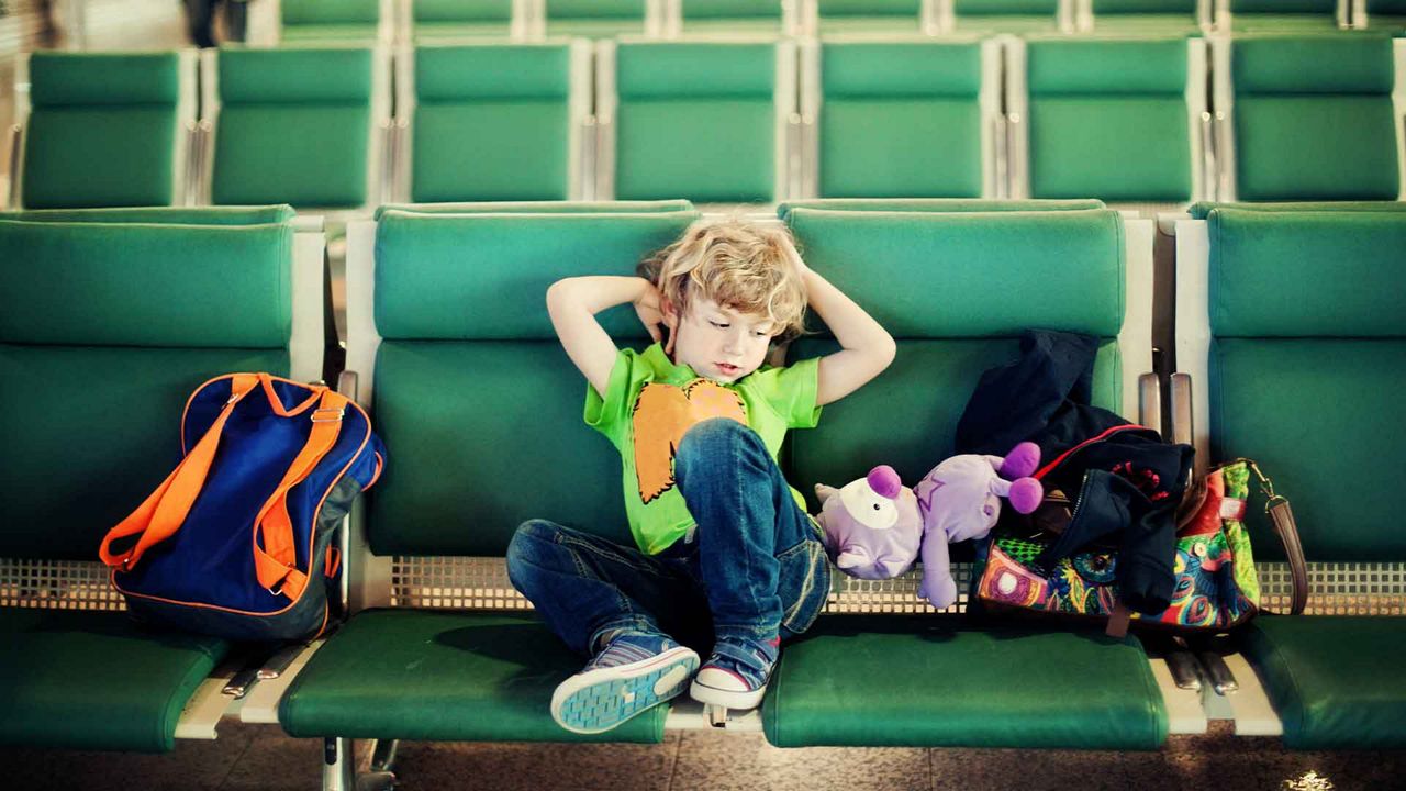 Little boy sitting on a chair at the airport