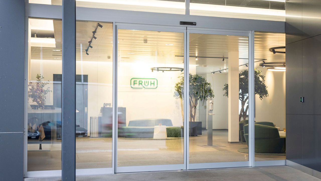 Image: The ASSA ABLOY SL00 Strong is a sleek, space-saving telescopic sliding door, ideal for modern office entrances