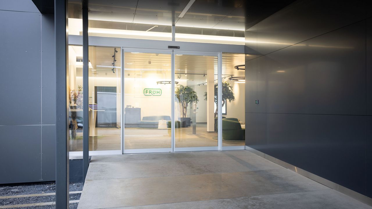 The ASSA ABLOY SL00 Strong is a sleek, space-saving telescopic sliding door, ideal for modern office entrances