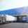 Exterior view of loading dock with white truck.