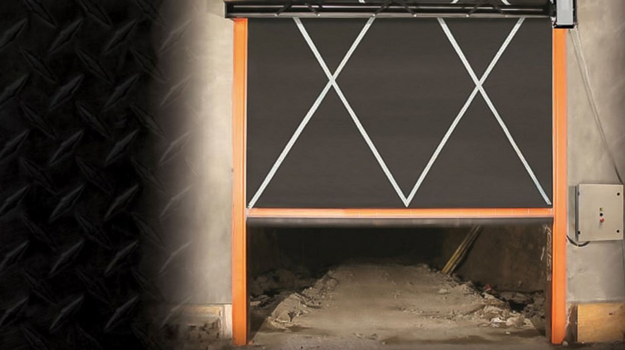 A high speed door that is about to open, and inside you can see a mining enviroment. 