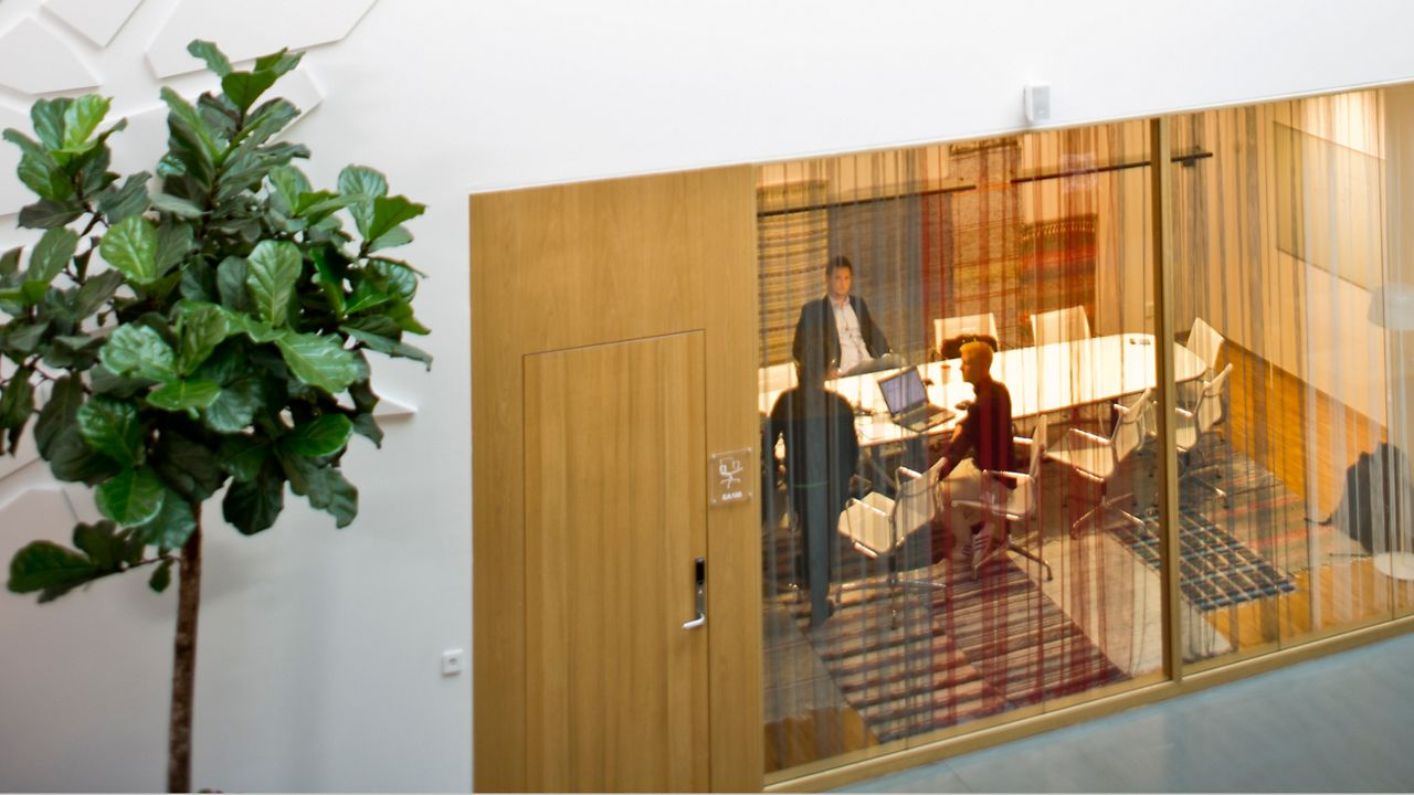 Kontor och konferensrum i glada färger sett från en atriumgård.