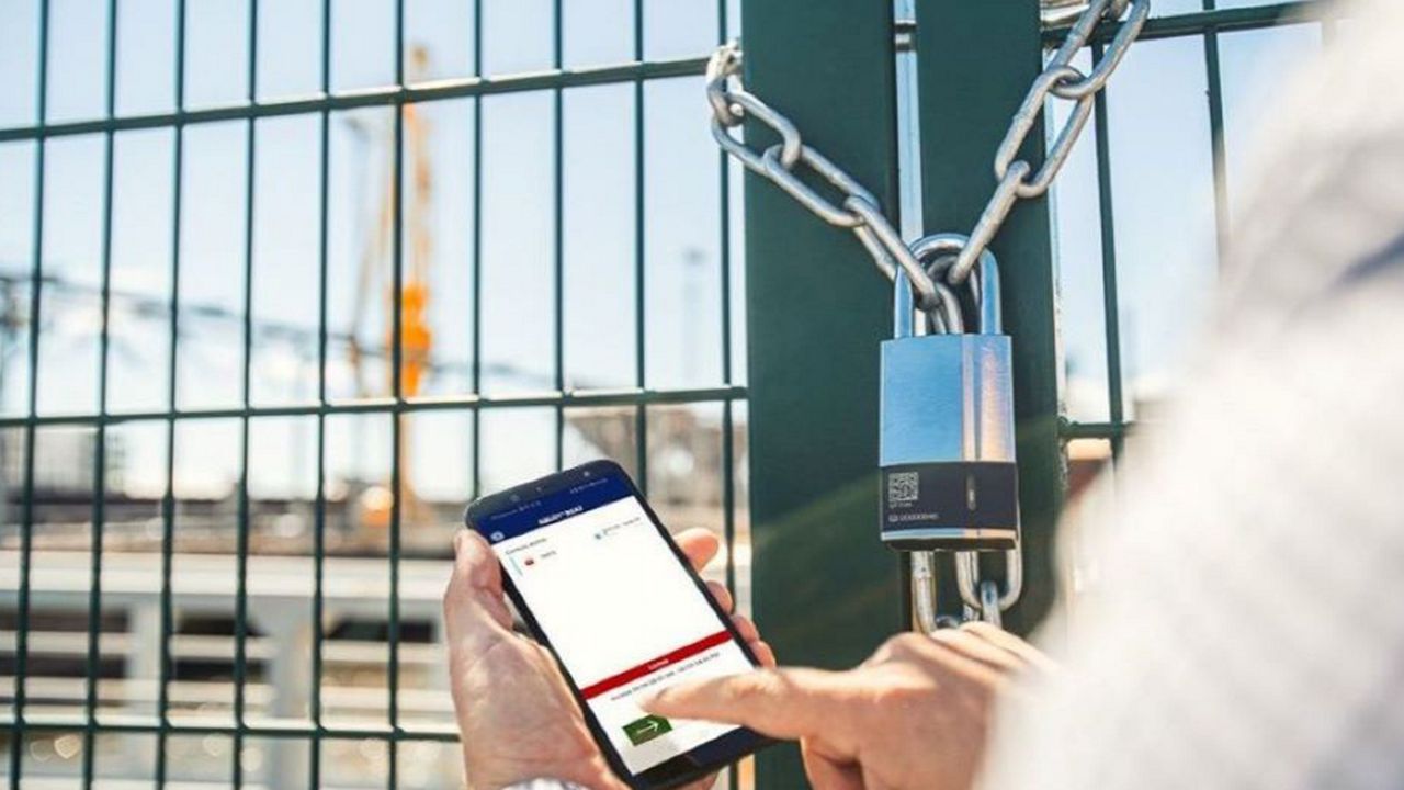 A keyless padlock being opened with a mobile phone.