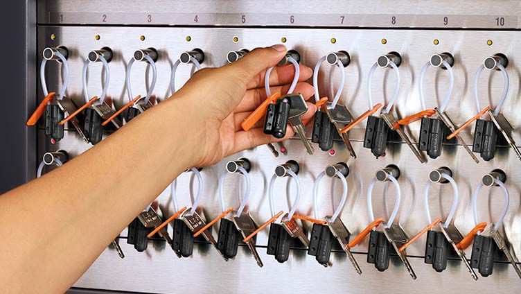 An employee getting access to the secure keys cabinet
