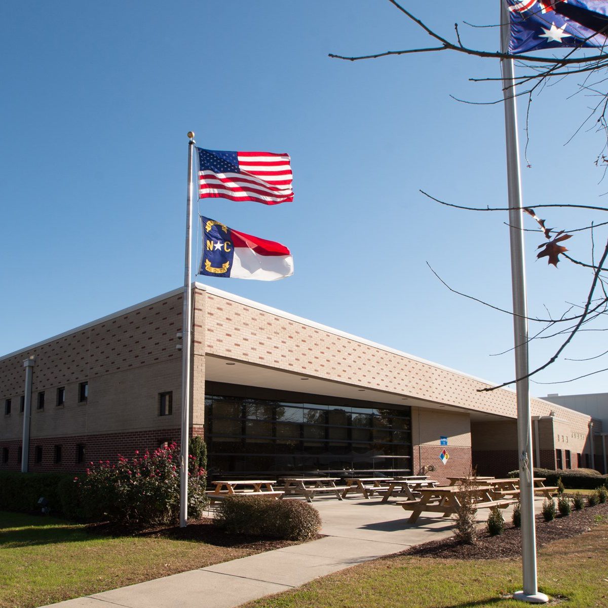 School brick building with americian flag in front