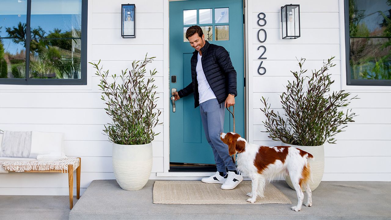 Man and pet dog with blue door