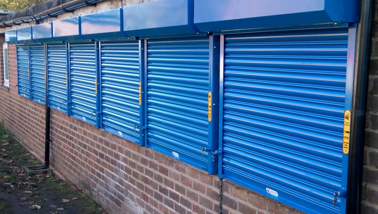 A row of manual roller shutter on an out industrial building 