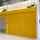 Two yellow painted ASSA ABLOY fire roller shutter in-situ within a manufacturing centre  