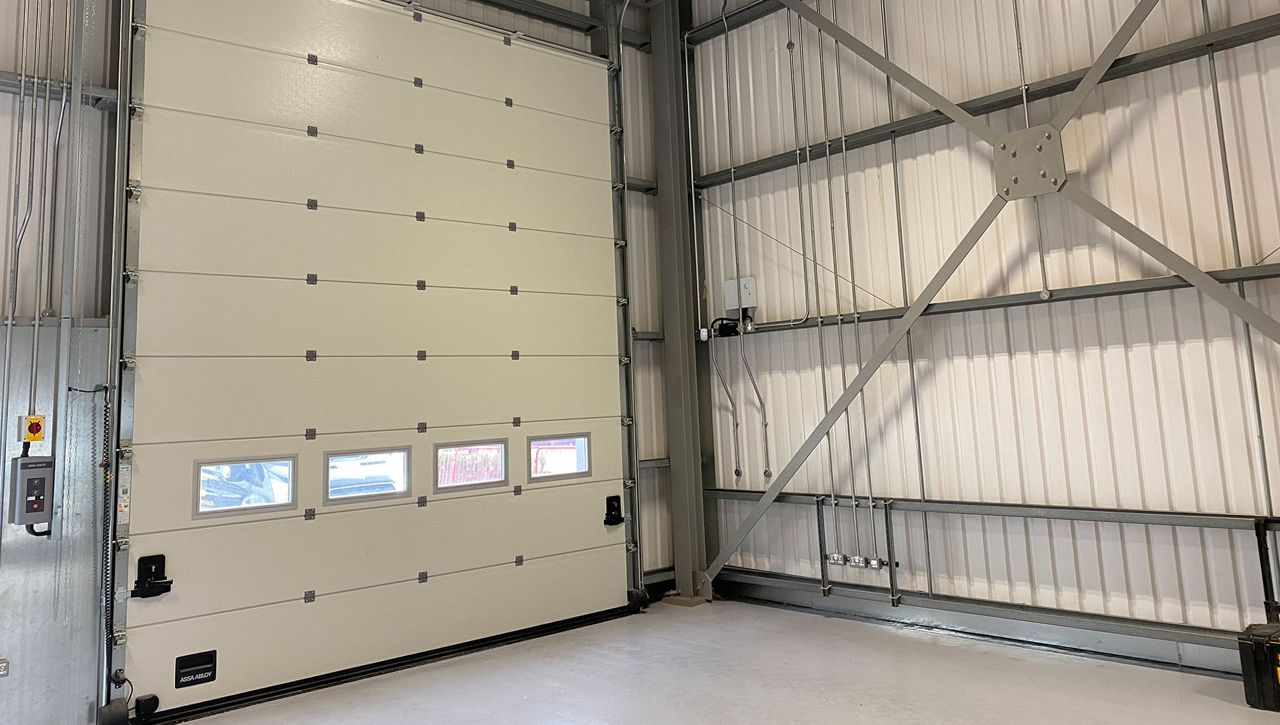 An internal image of a Crawford OH1042P secured by design overhead sectional door at a manufacturing site