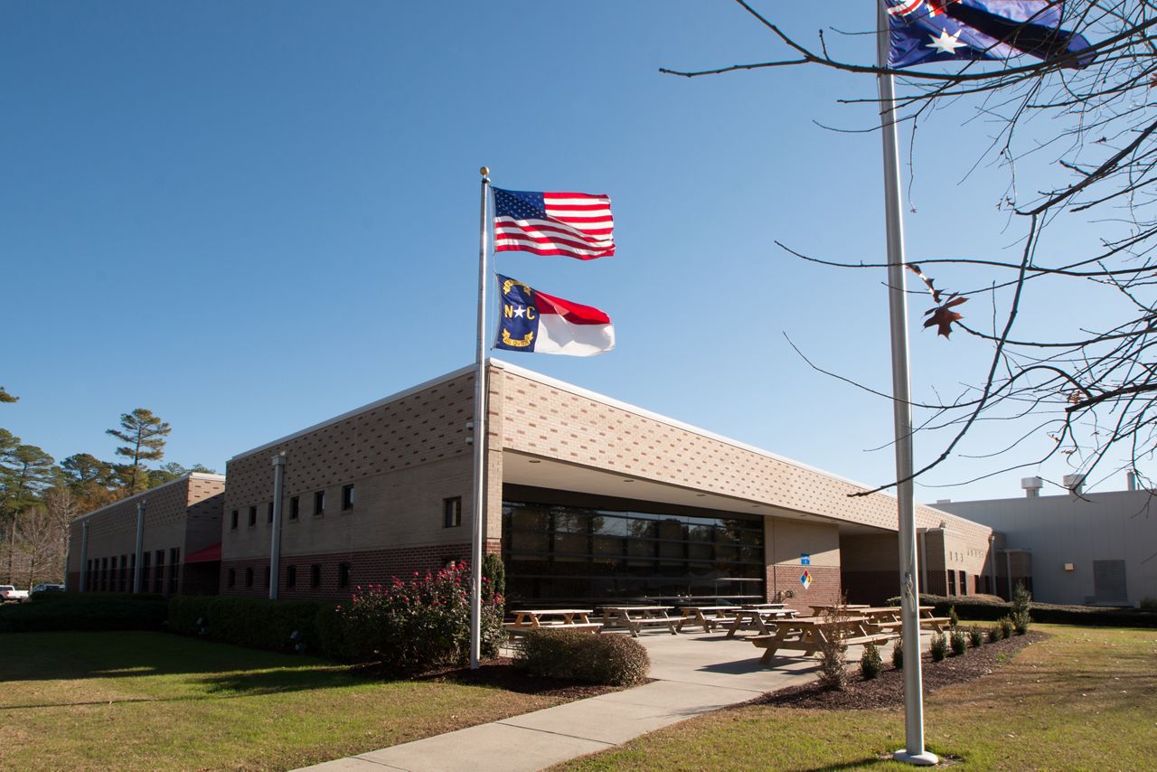 School brick building with americian flag in front
