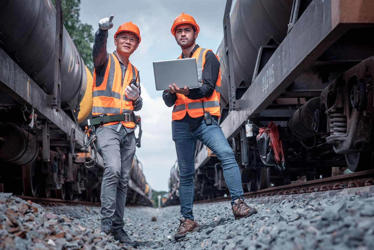 Rail workers using laptop and radio devices