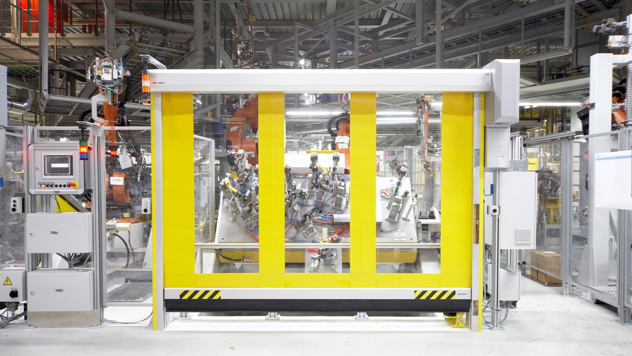 A yellow RP300 door with windows in a industrial enviroment. 