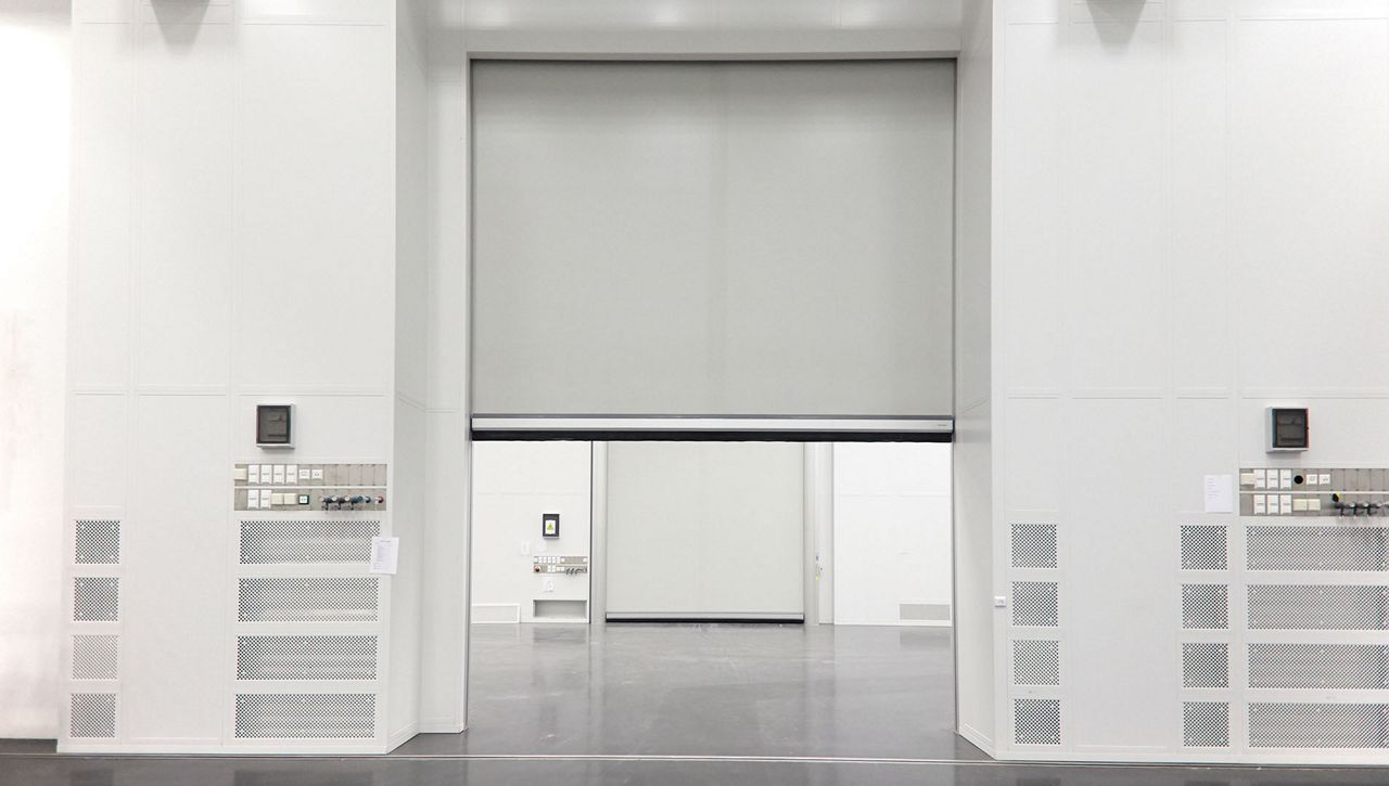 Image: ASSA ABLOY RR300 clean high speed door in the opens position in a cleanroom manufacturing environment