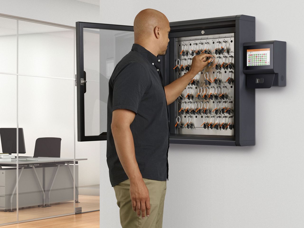 male using a Traka key cabinet in the office