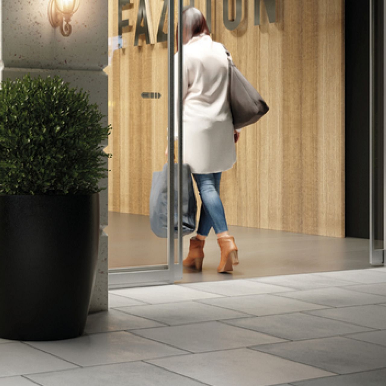 A customer enters a boutique through an automatic sliding door