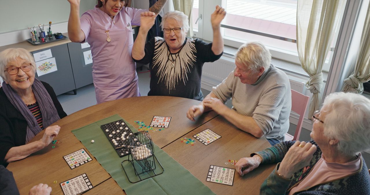 Care home residents playing bingo.