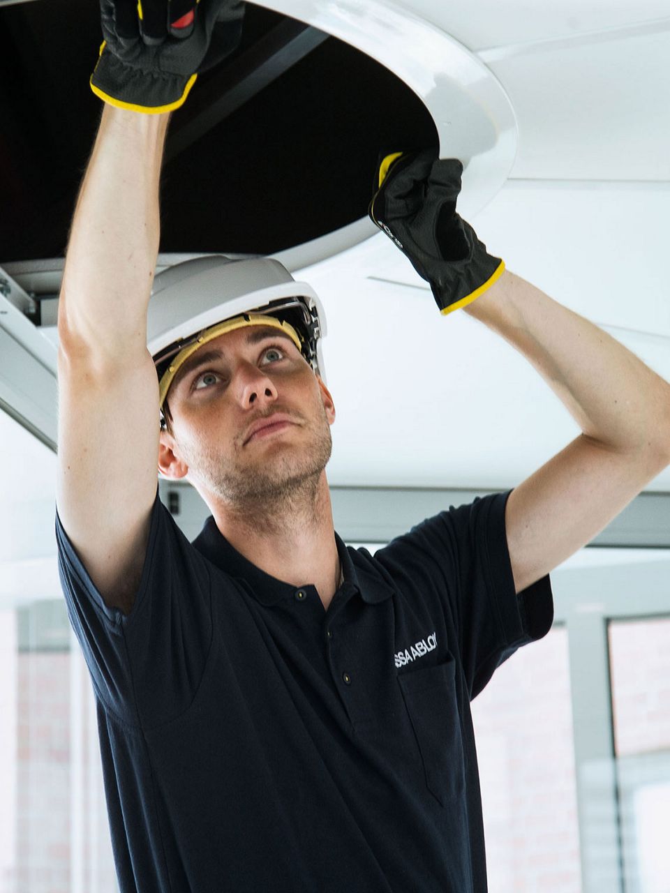 ASSA ABLOY service technician fixing an automatic door