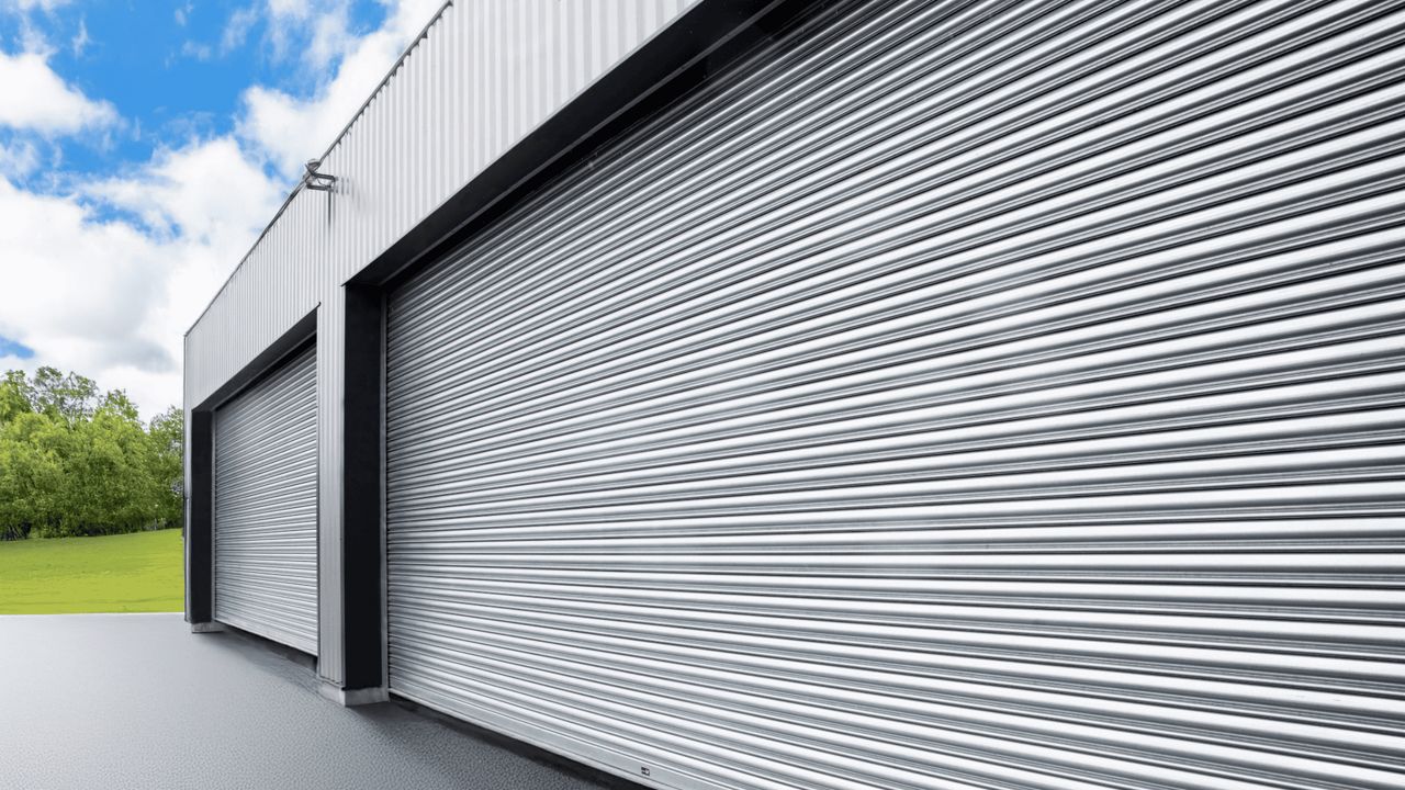 Industrial building seen from the side with a large roller shutter.