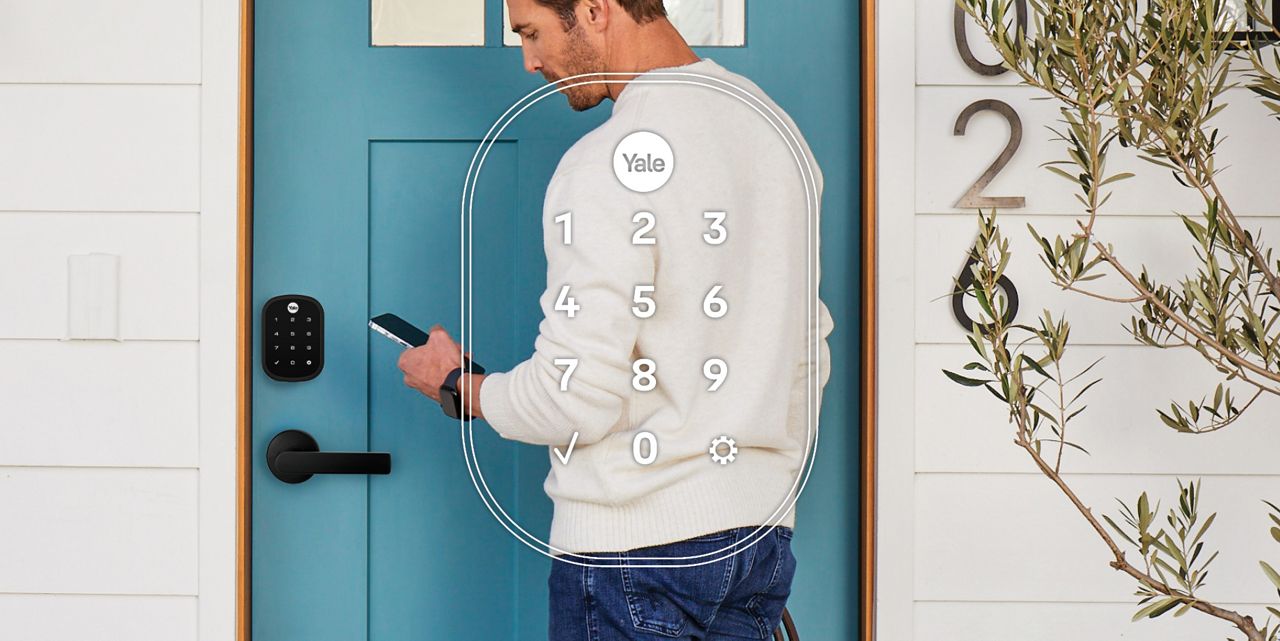 Man in front of door with smartphone