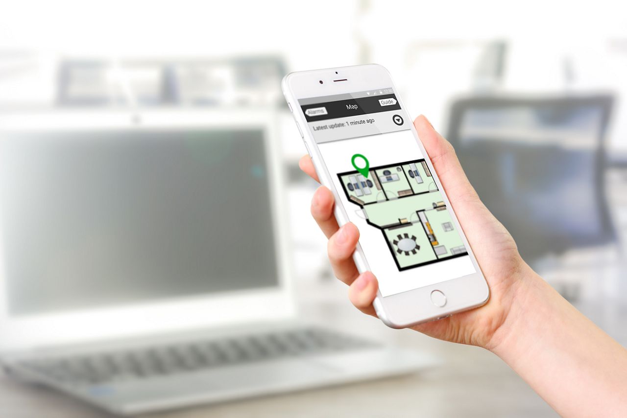 Holding a phone with 9solutions smooth lite app
