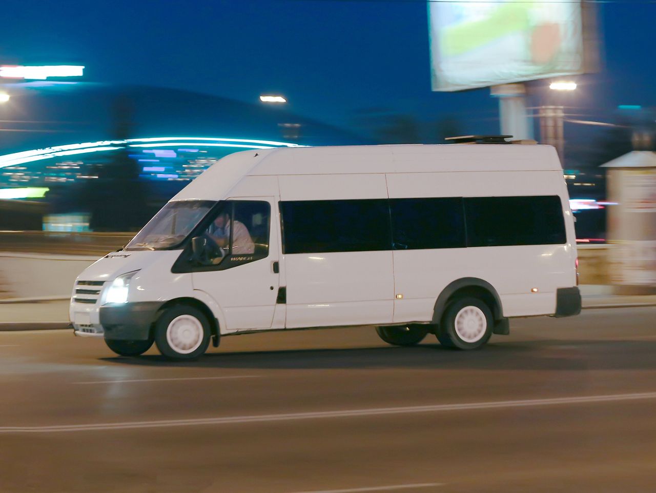 Passenger van on the road at night