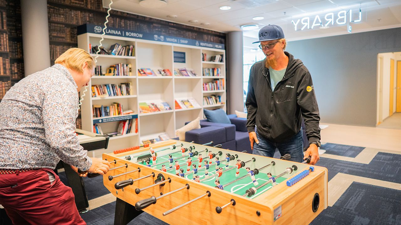 Markku and Tapani playing table football.