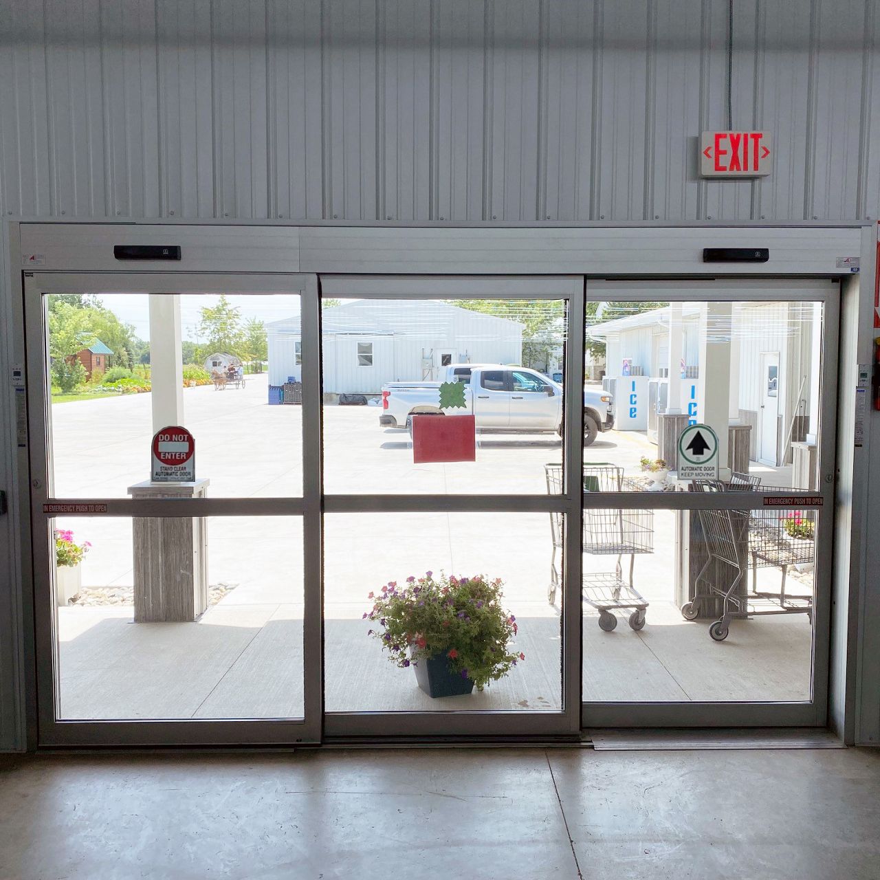 A tandem automatic sliding door package in use at a grocery store.