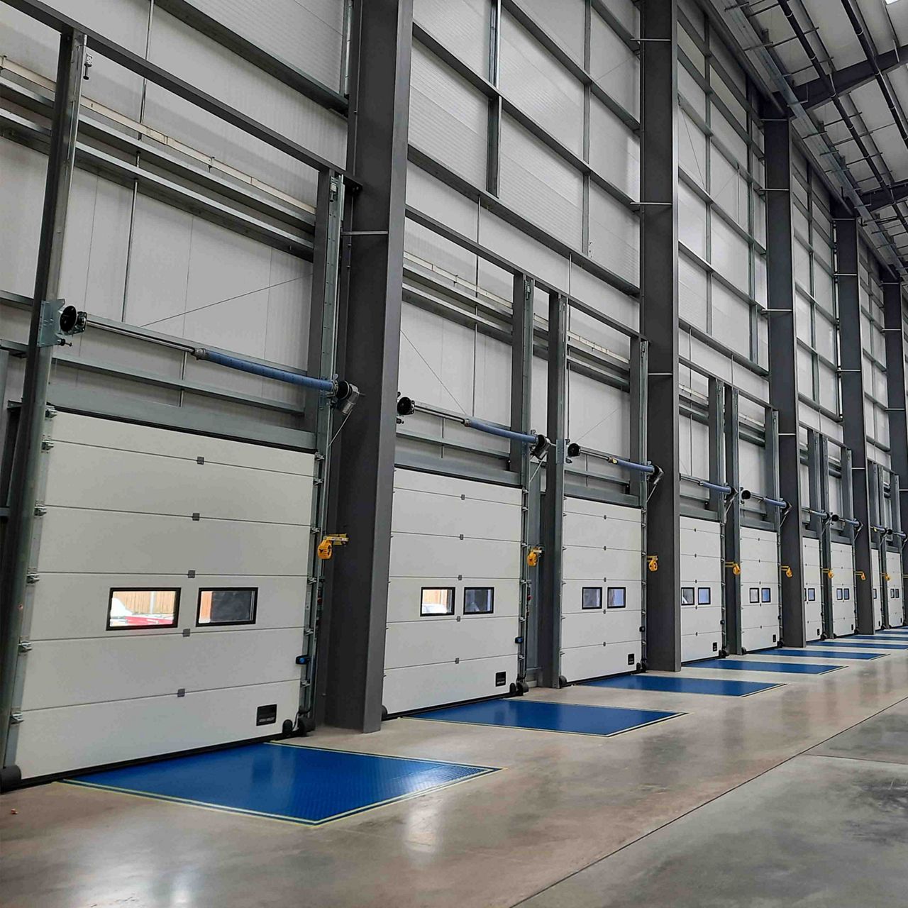 A row of ASSA ABLOY dock doors and dock levellers at industrial commercial development