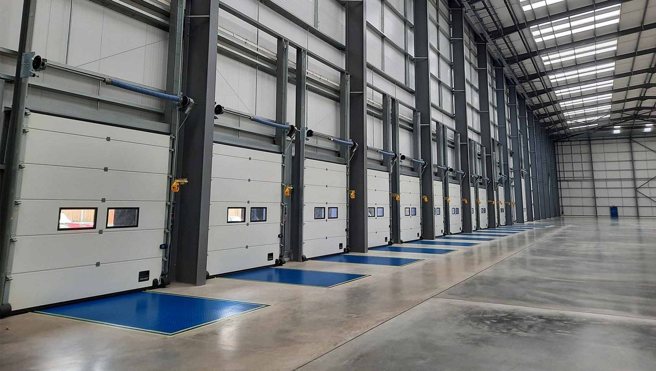 A row of ASSA ABLOY dock doors and dock levellers at industrial commercial development