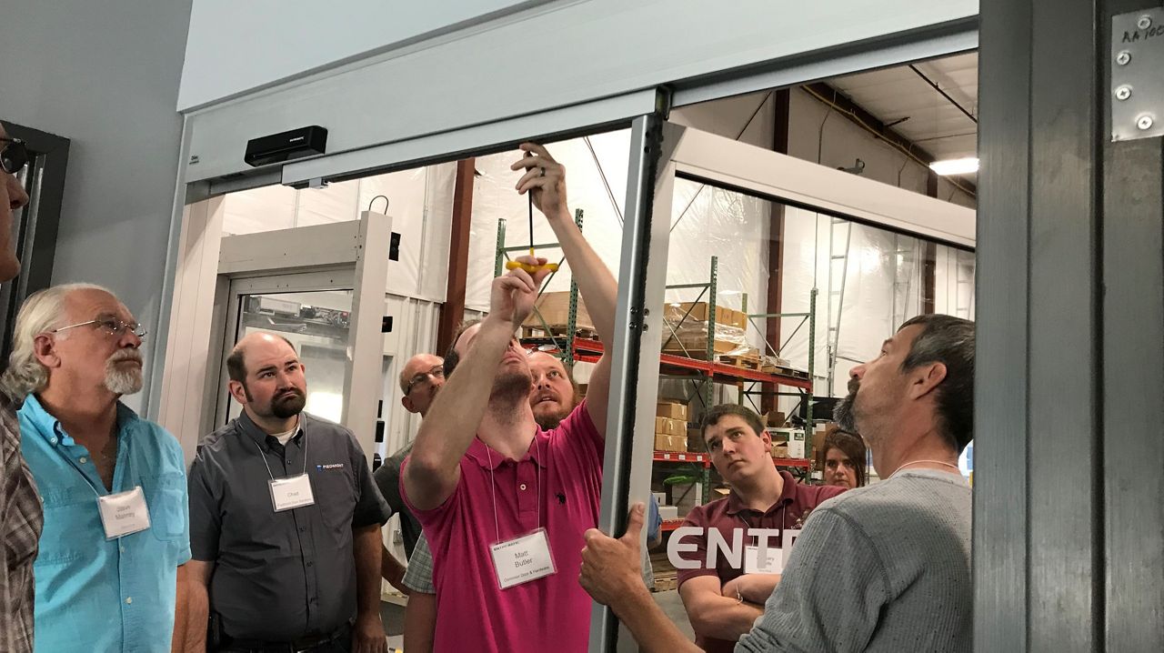 people learning how to install a sliding door