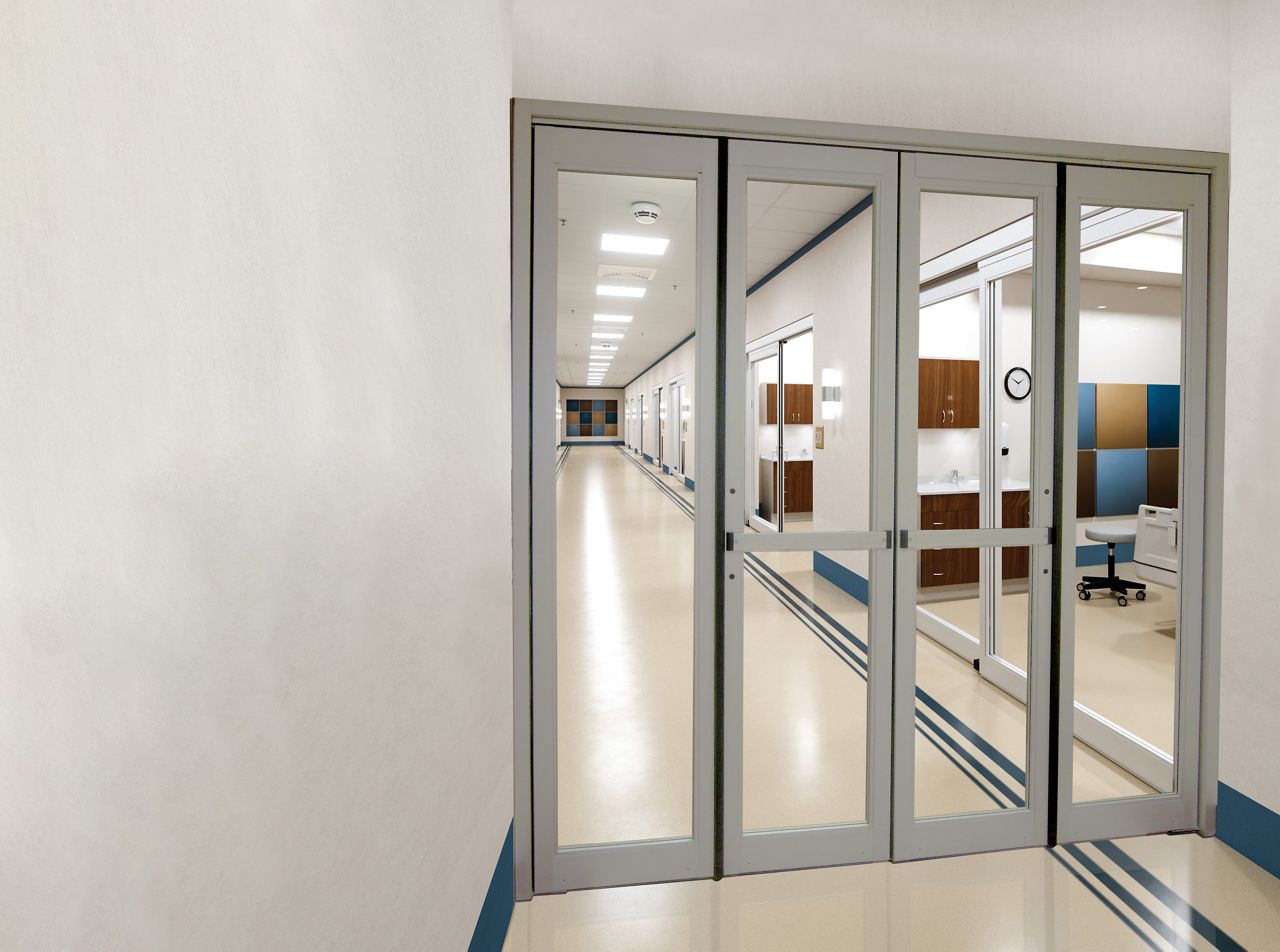 The ASSA ABLOY VersaMax 2.0 Fold ICU door in a hospital hallway.