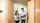 Two people walking through acoustic door in office.