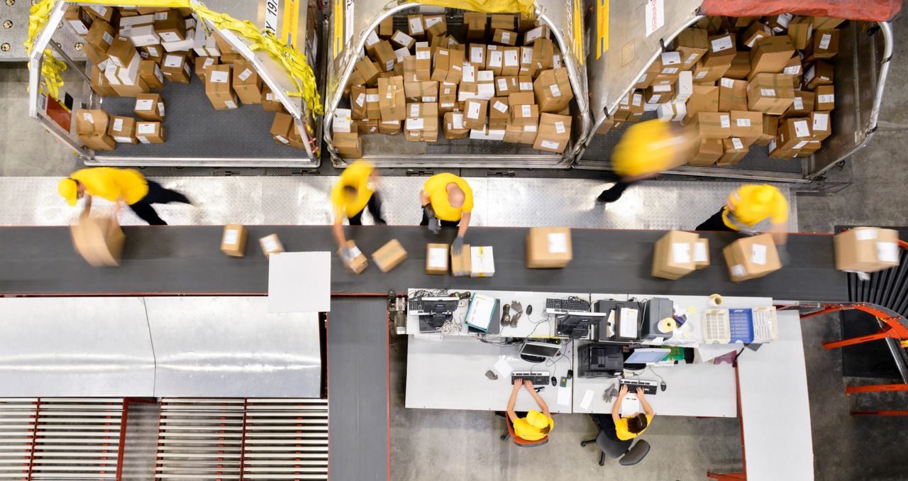 Warehouse workers sorting packages
