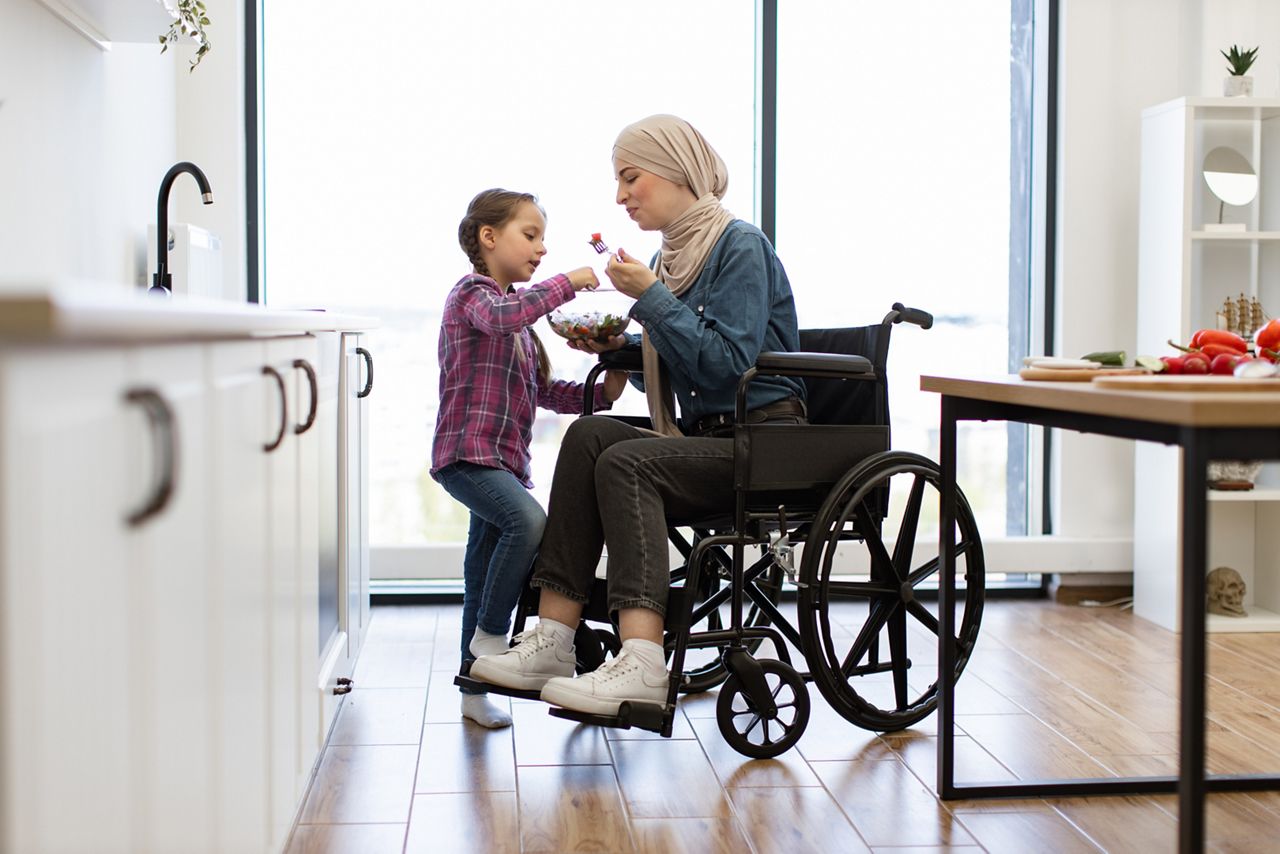 Woman in wheelchair with child.