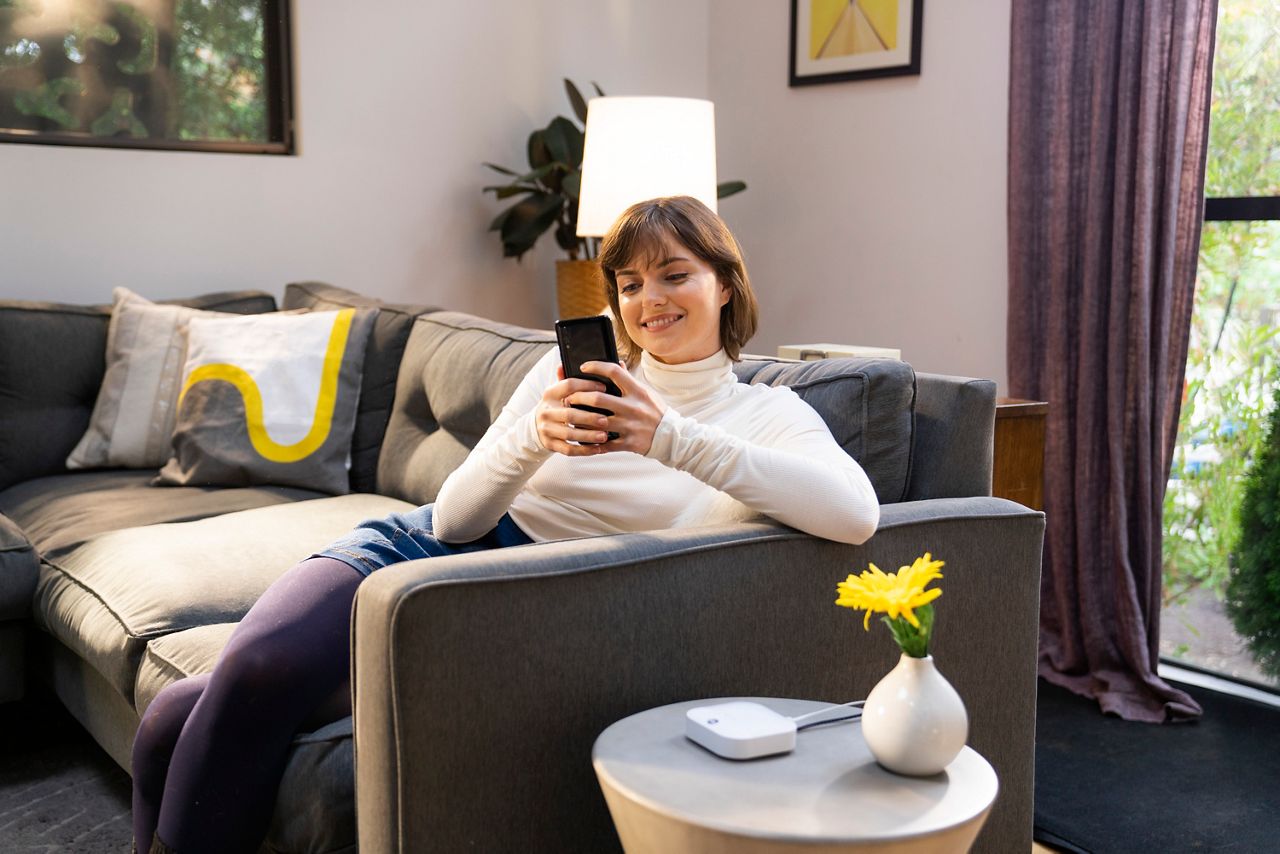 Woman smiling while checking phone