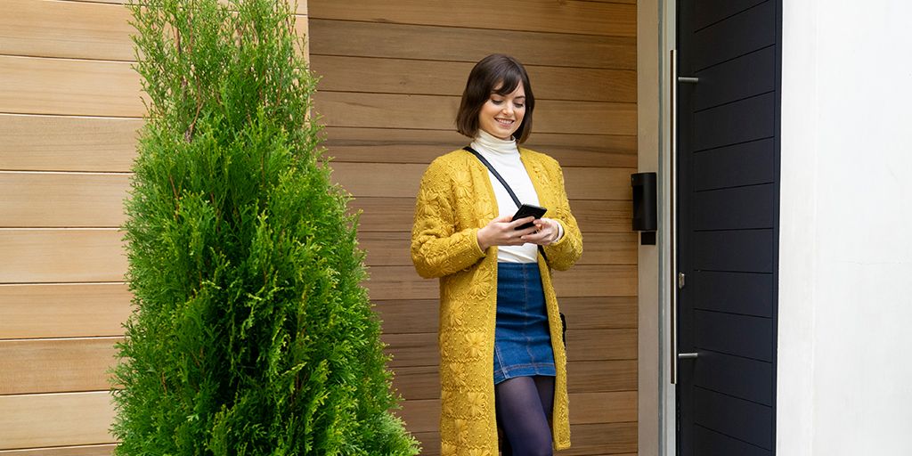 Image: ac97b-womansmilingwithphonehighres